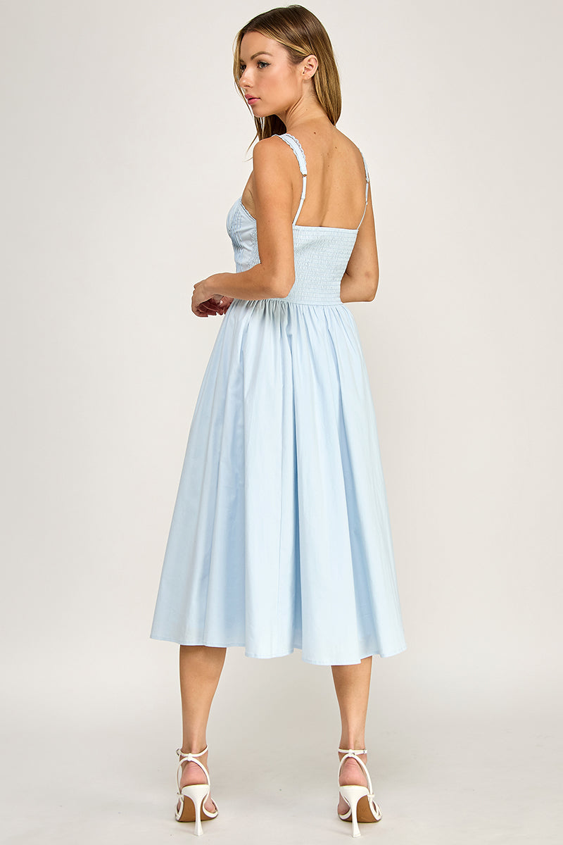 Woman wearing a sleeveless dress on a white background