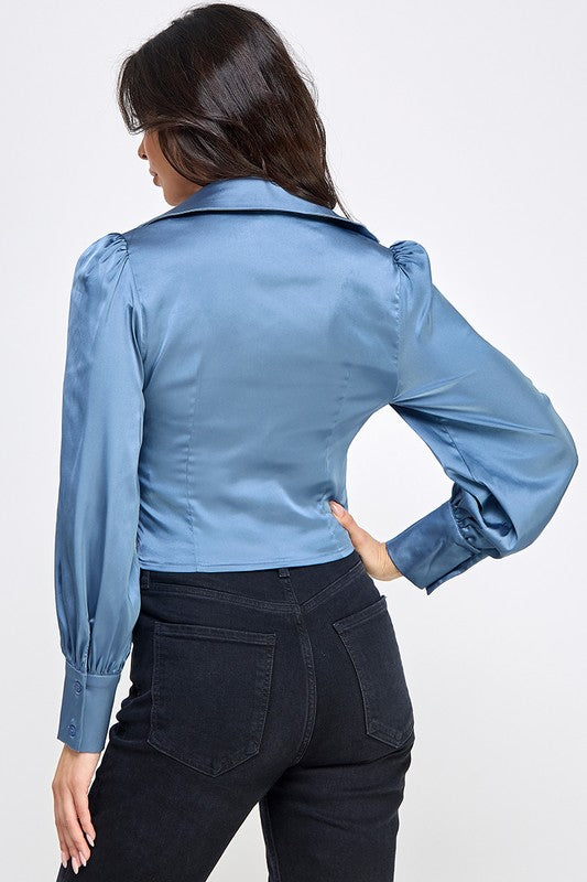 Woman wearing a satin blouse against a white background