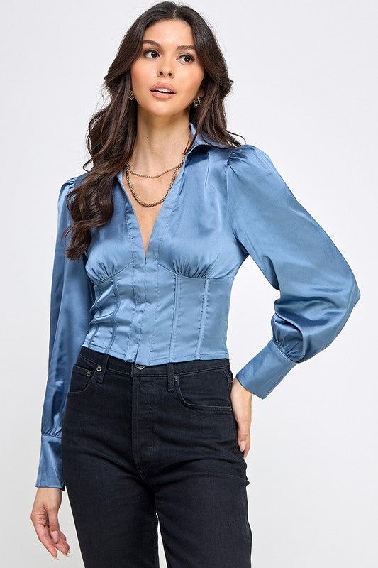 Woman wearing a satin blouse against a white background
