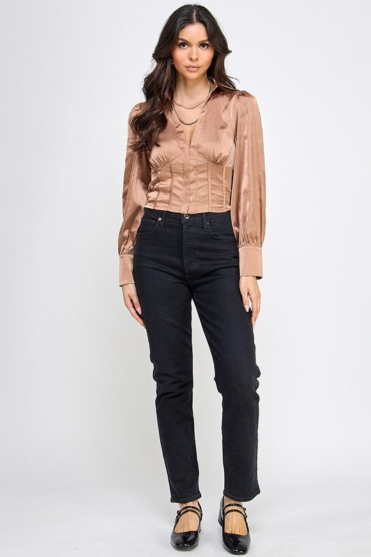Woman wearing a satin blouse against a white background