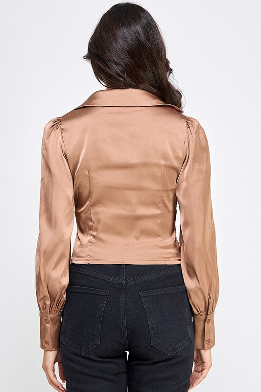 Woman wearing a satin blouse against a white background