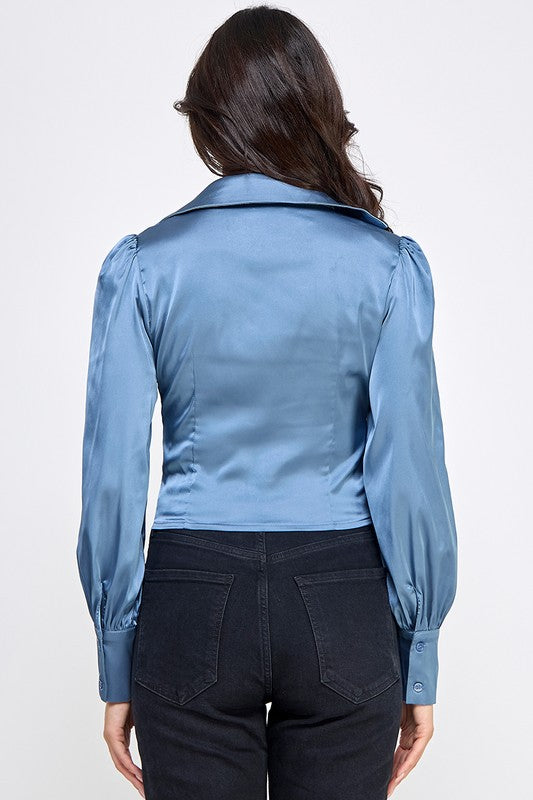 Woman wearing a satin blouse against a white background