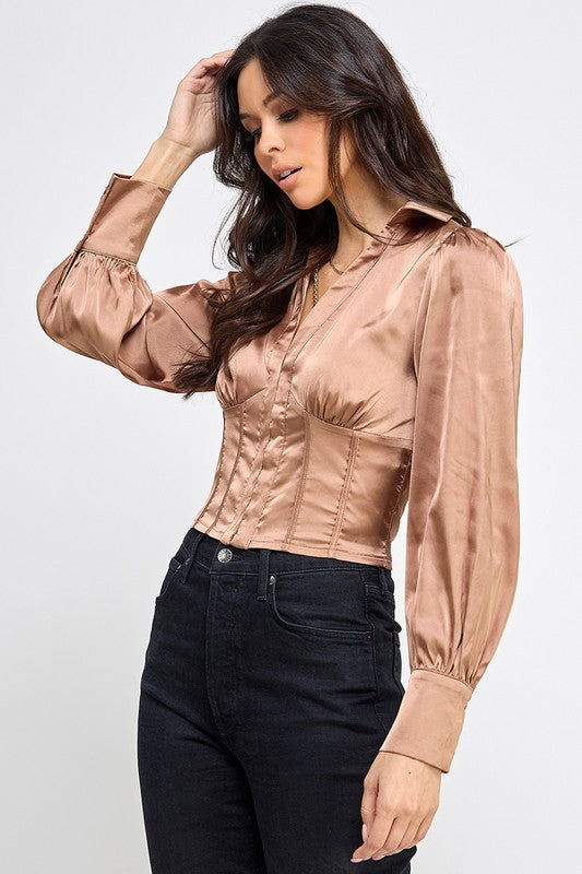 Woman wearing a satin blouse against a white background