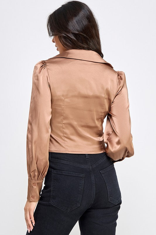 Woman wearing a satin blouse against a white background