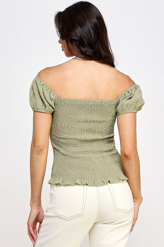 Woman wearing a top with a bow detail on a white background