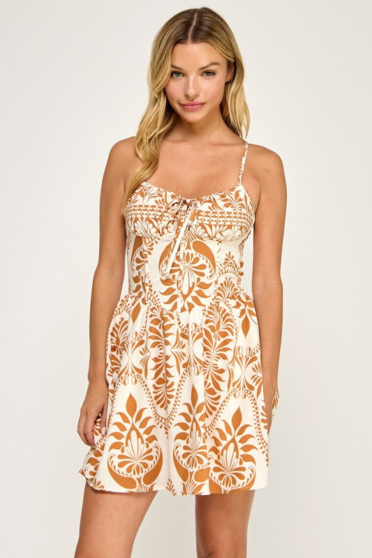 Woman wearing a patterned dress on a plain background