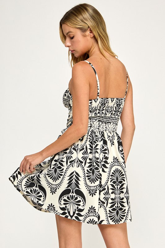 Woman wearing a patterned dress on a plain background