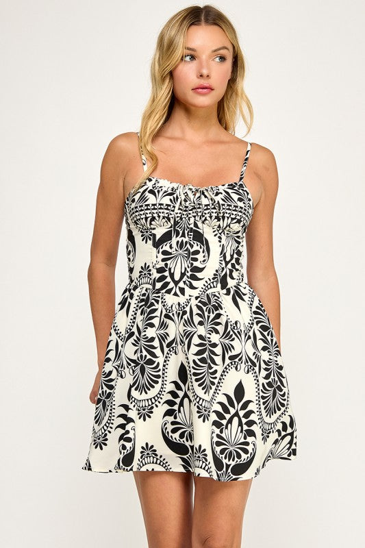 Woman wearing a patterned dress on a plain background