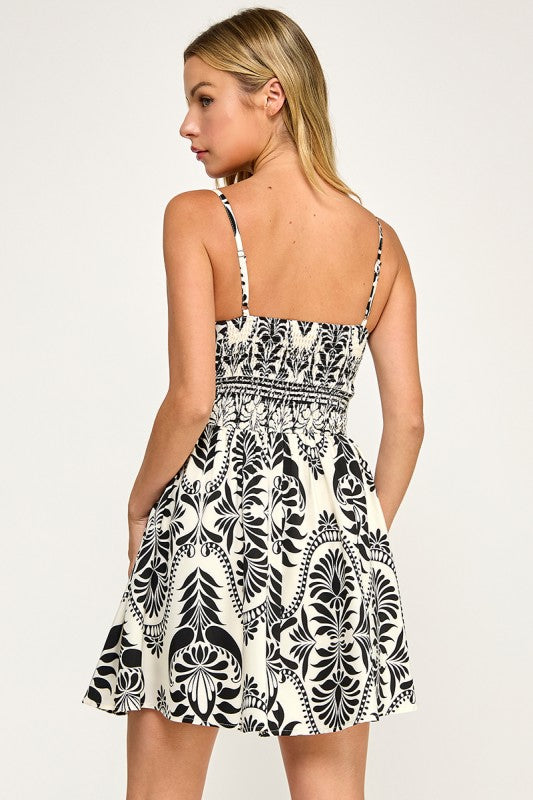 Woman wearing a patterned dress on a plain background