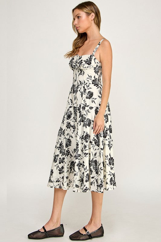 Woman wearing a floral dress on a plain background