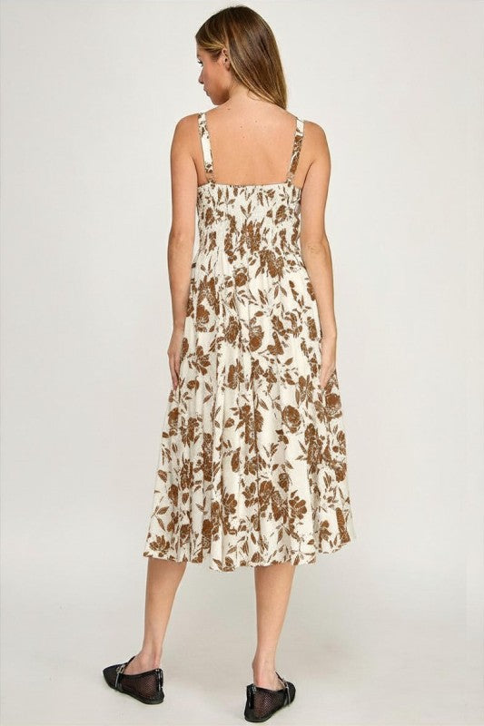 Woman wearing a floral dress on a plain background