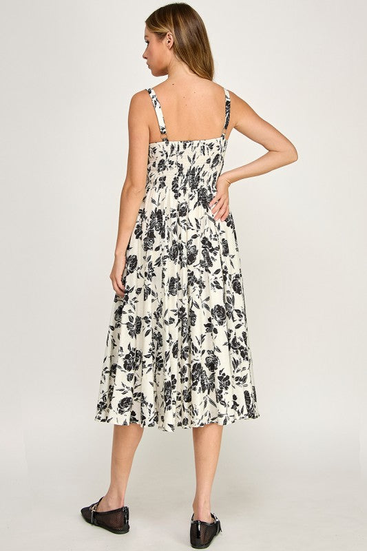 Woman wearing a floral dress on a plain background