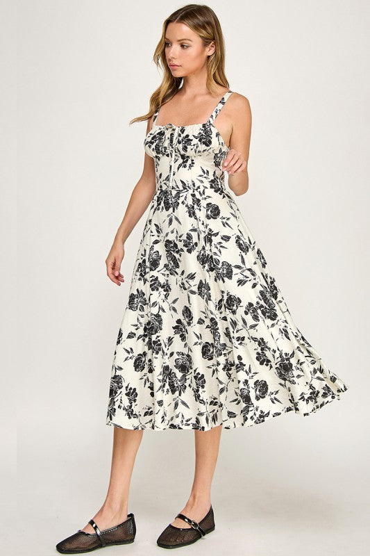 Woman wearing a floral dress on a plain background