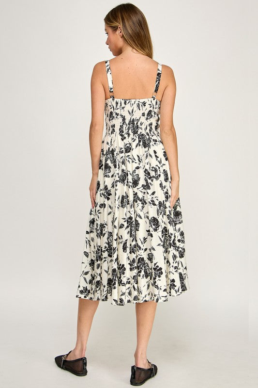 Woman wearing a floral dress on a plain background