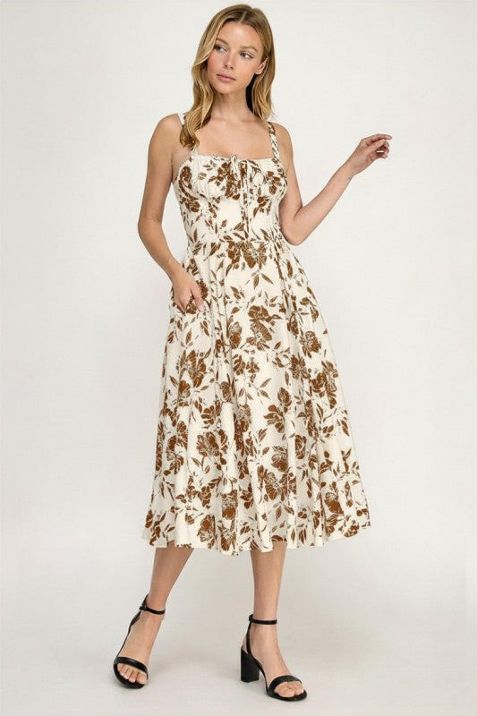 Woman wearing a floral dress on a plain background