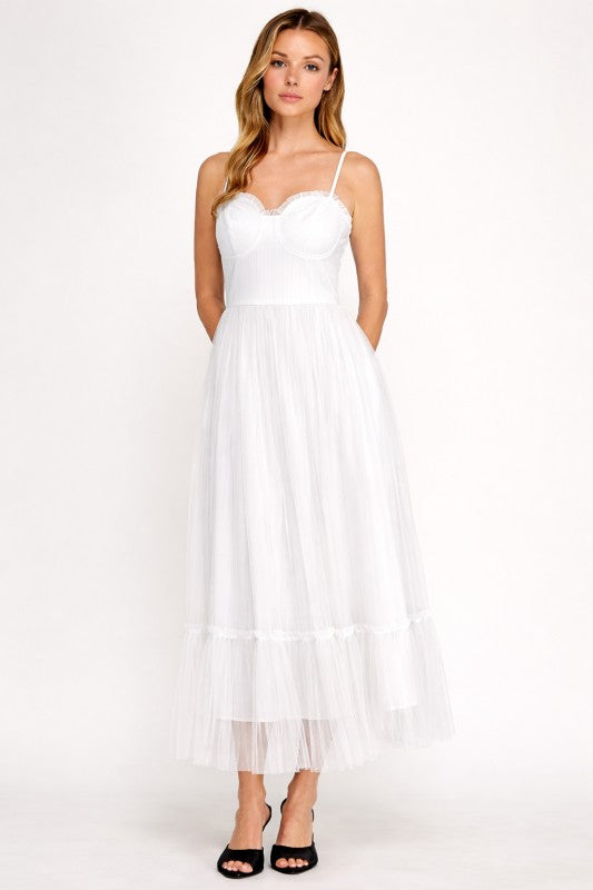 Woman wearing a dress with sheer overlay on a white background