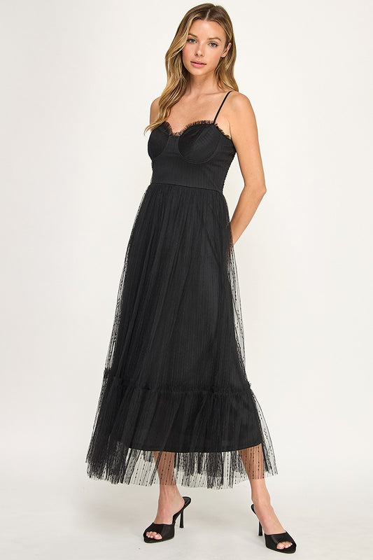 Woman wearing a dress with sheer overlay on a white background