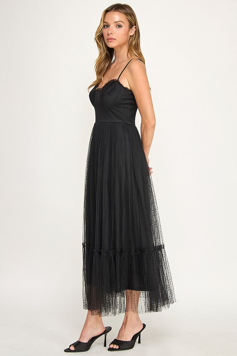 Woman wearing a dress with sheer overlay on a white background
