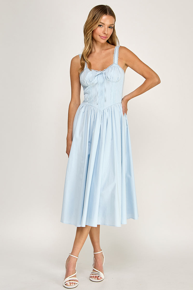 Woman wearing a sleeveless dress on a white background