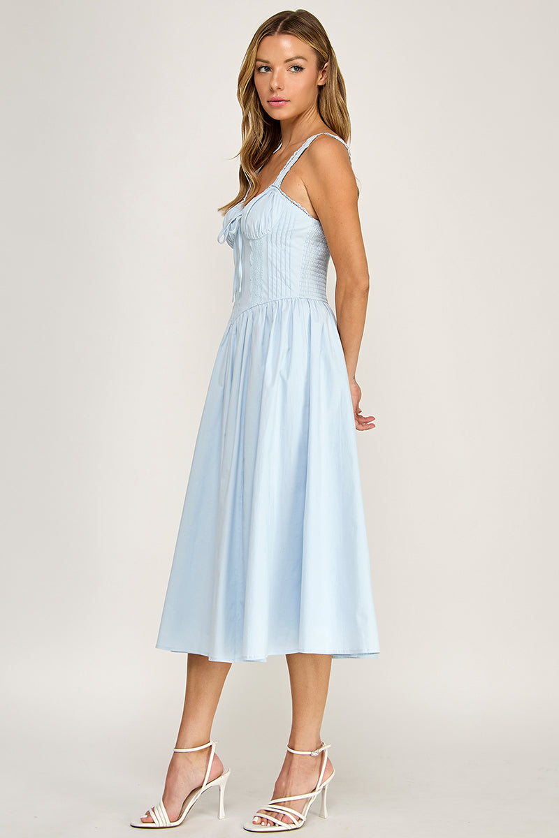 Woman wearing a sleeveless dress on a white background