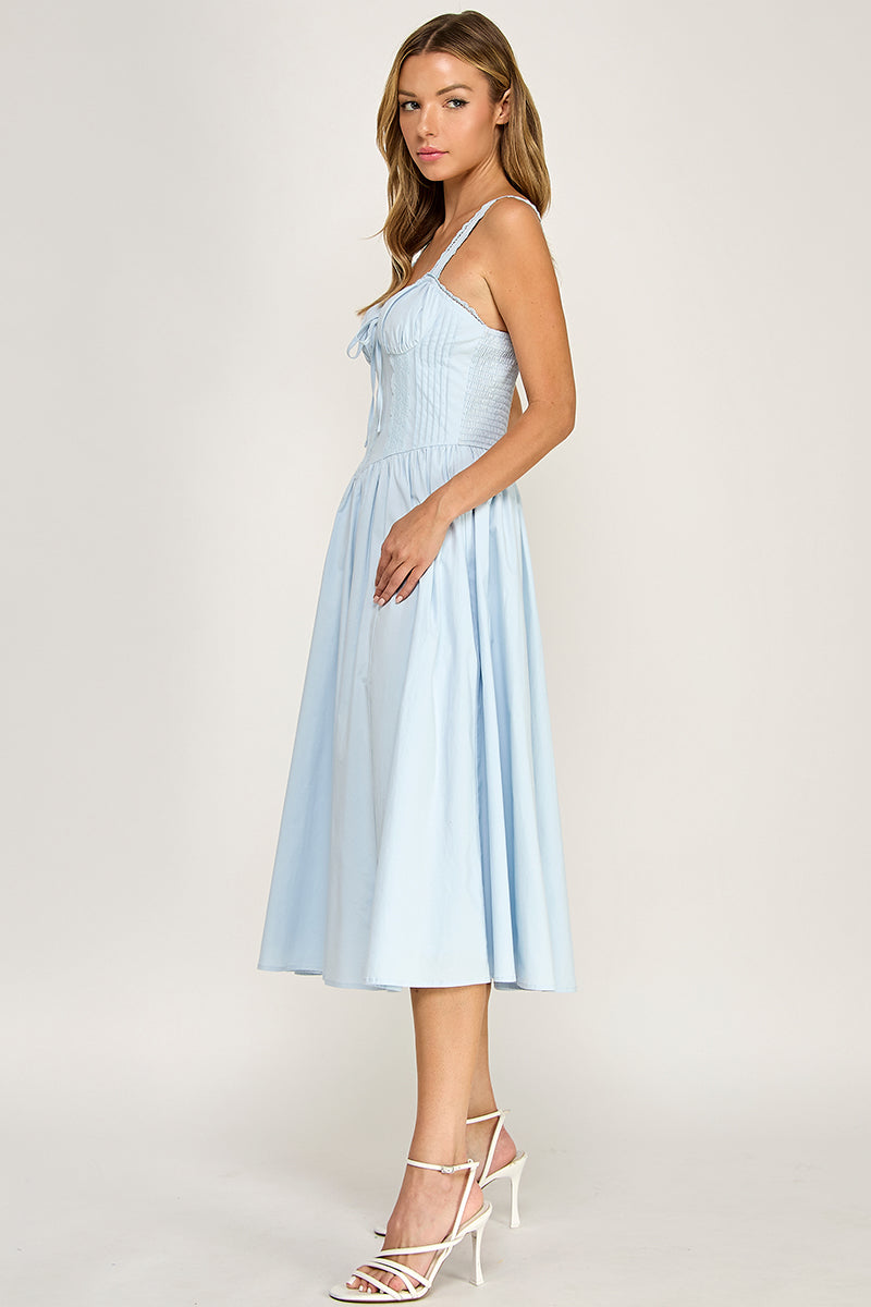 Woman wearing a sleeveless dress on a white background