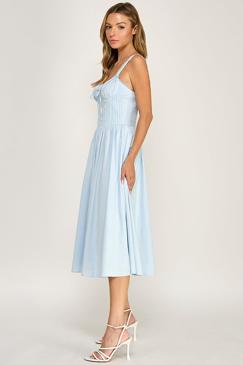 Woman wearing a sleeveless dress on a white background