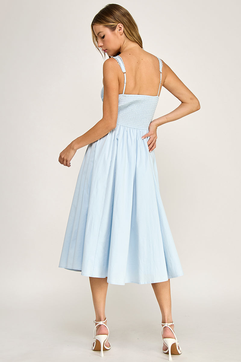 Woman wearing a sleeveless dress on a white background