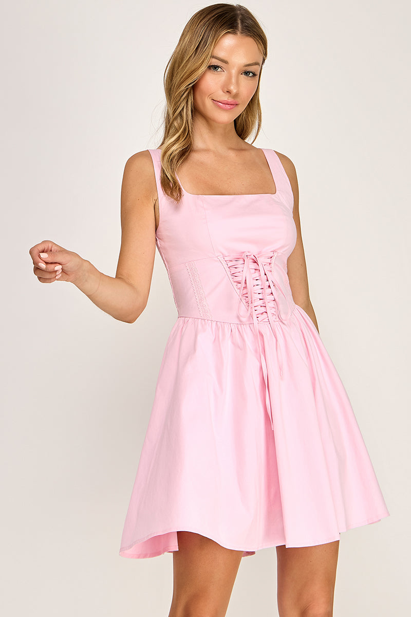 Woman wearing a dress on a plain background