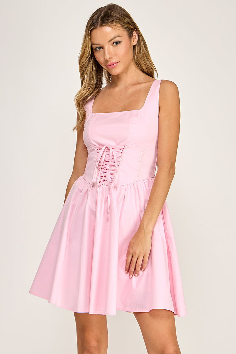 Woman wearing a dress on a plain background