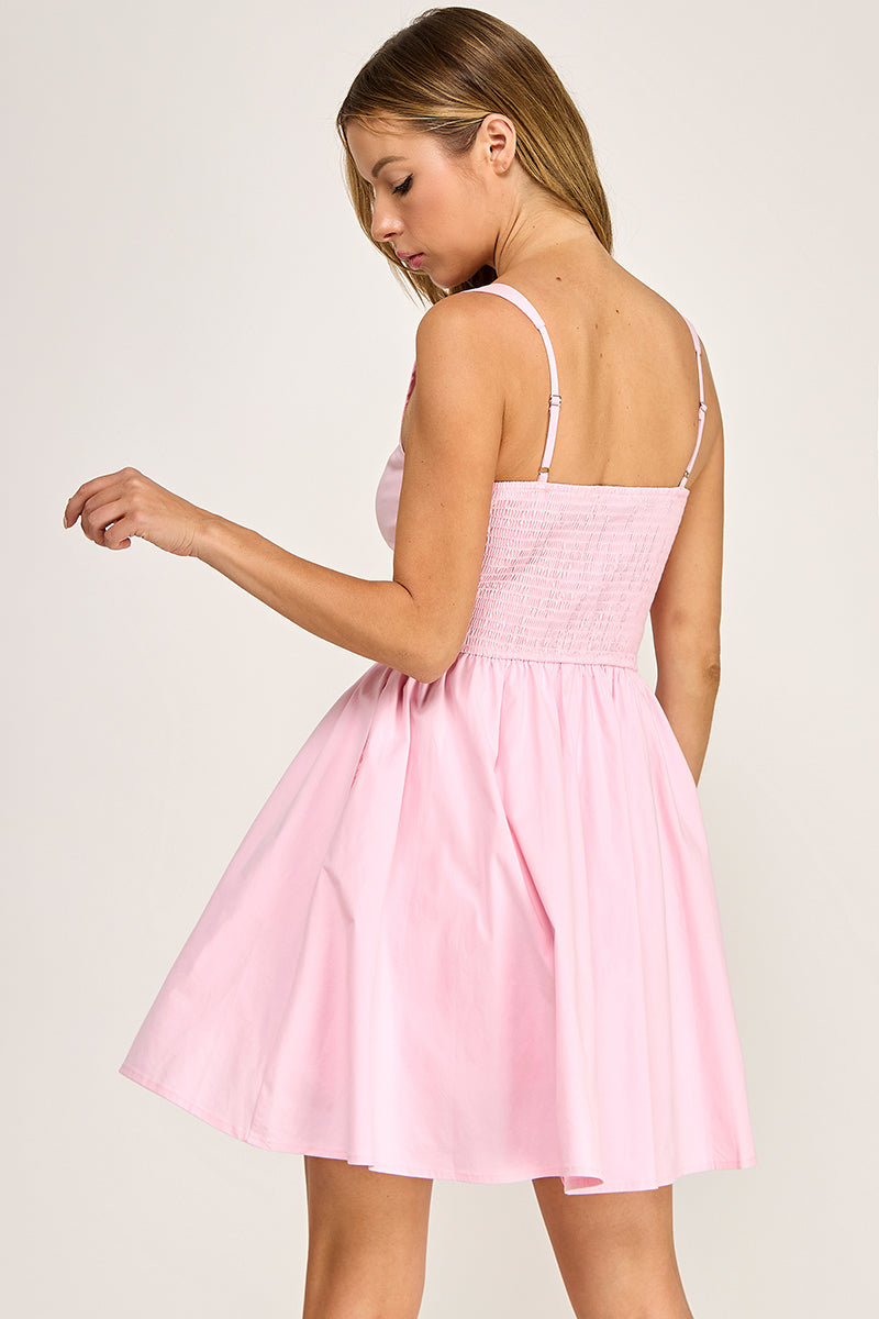 Woman wearing a dress on a plain background