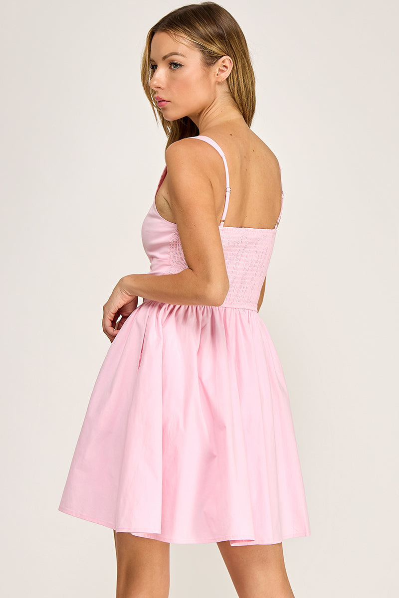 Woman wearing a dress on a plain background