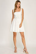 Woman wearing a dress on a plain background