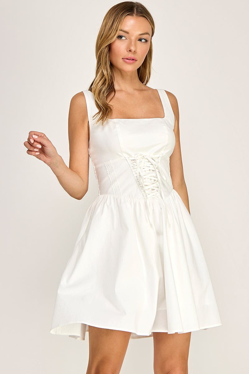 Woman wearing a dress on a plain background