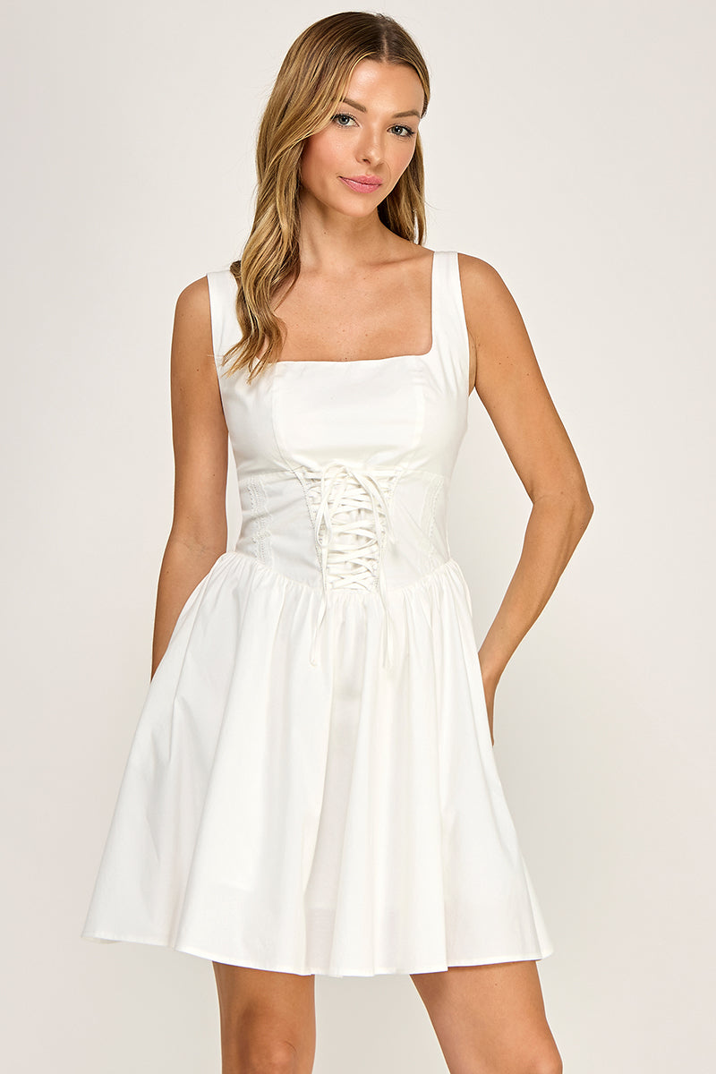 Woman wearing a dress on a plain background