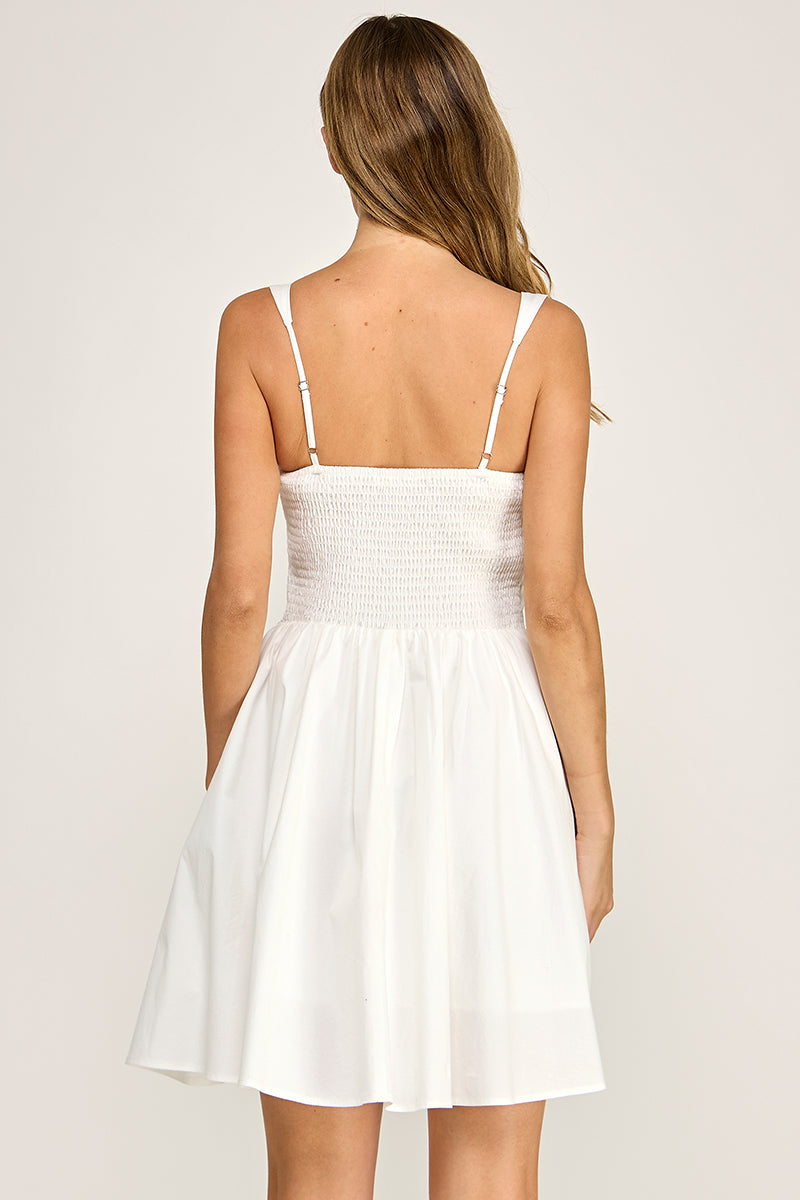 Woman wearing a dress on a plain background